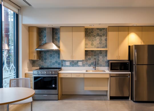 a kitchen with stainless steel appliances and a table