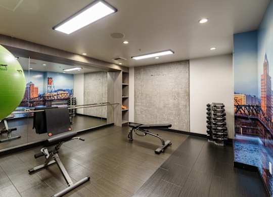 A gym with a green ball and a row of exercise chairs.