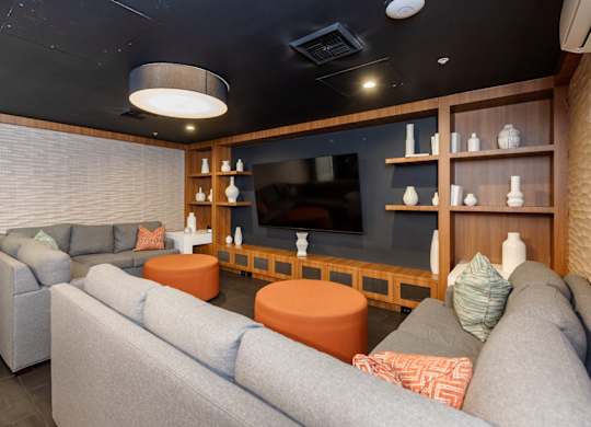 A living room with grey couches and a television.