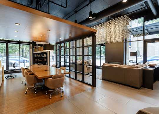 A modern living room with a dining table and chairs.