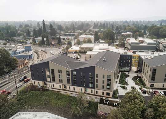 A view of a campus with buildings and a road.