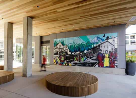 a large mural in the breezeway of an apartment building with a circular seating area at Slabtown Square Apartments, Portland ,Oregon, 97209