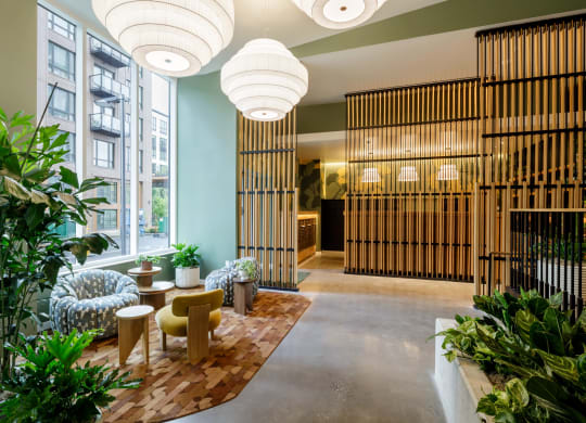 a lobby with a seating area and plants at Slabtown Square Apartments, Portland ,Oregon, 97209