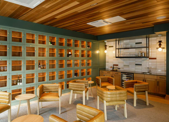 a bar with wooden chairs and a wall with shelves at Slabtown Square Apartments, Portland ,Oregon, 97209