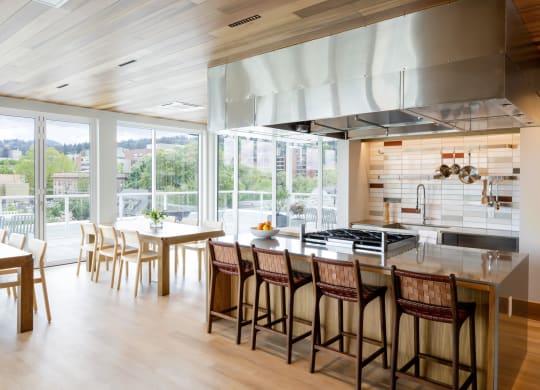 the kitchen and dining area of a modern house with a large kitchen island and chairs at Slabtown Square Apartments, Oregon