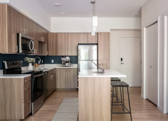 a kitchen with wooden cabinets and a white counter top
