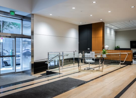 a conference room with a glass table and chairs and a large window