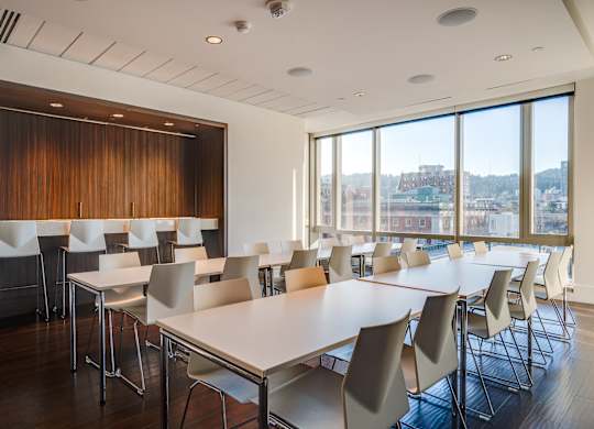 A conference room with a long table and chairs.