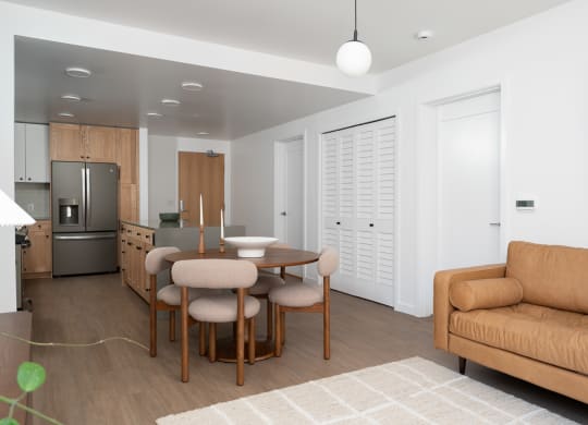a living room and kitchen with a dining table and a couch at Slabtown Square Apartments, Oregon