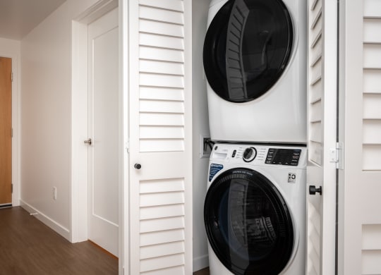 a washer and dryer in a laundry room with a white closet at Slabtown Square Apartments, Portland , OR 97209