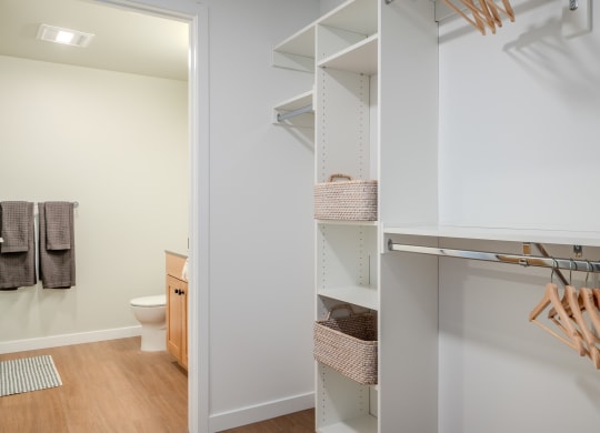 a walk in closet in a bathroom with a toilet at Slabtown Square Apartments, Oregon