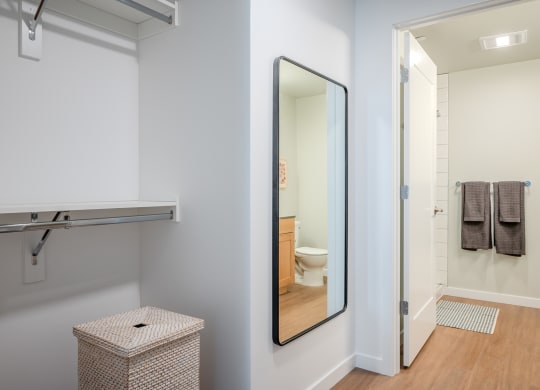 a bathroom with a mirror and a towel rack and a toilet at Slabtown Square Apartments, Portland , OR