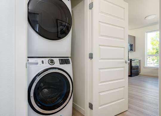 A white washing machine and dryer in a laundry room.