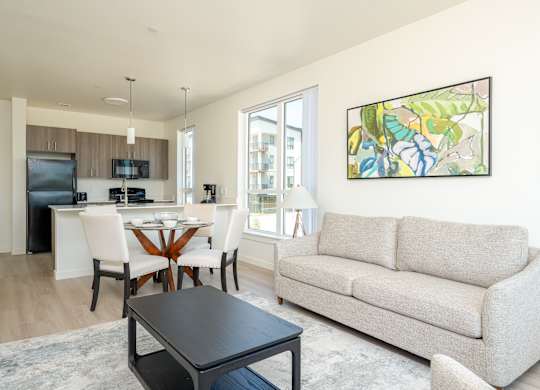 A modern living room with a dining table and a couch.