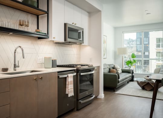 a kitchen with a sink and a stove and a microwave at Slabtown Square Apartments, Portland , OR 