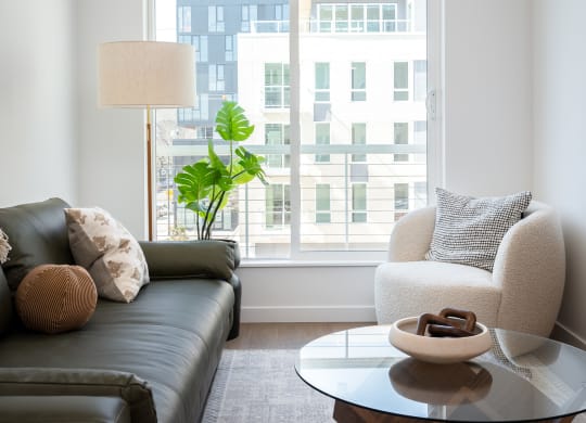 living room with a large window and a couch and a coffee table at Slabtown Square Apartments, Portland ,Oregon, 97209
