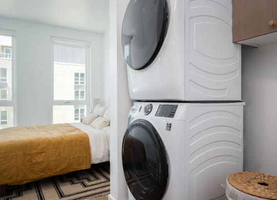 a bedroom with a washing machine and a bed with a washer and dryer at Slabtown Square Apartments, Portland 