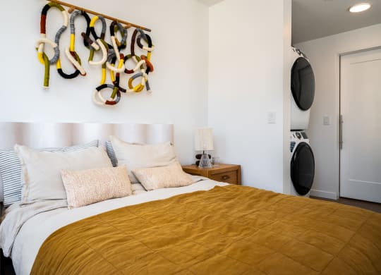 a bedroom with a bed and a wall with a rack of shoes on it at Slabtown Square Apartments, Portland , Oregon