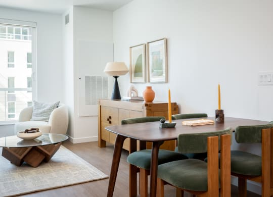 a dining room and living room with a table and chairs at Slabtown Square Apartments, Portland , OR 97209