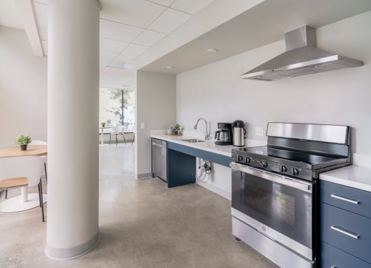 a kitchen with a stove top oven next to a column