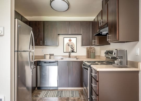 a kitchen with stainless steel appliances and wooden cabinets