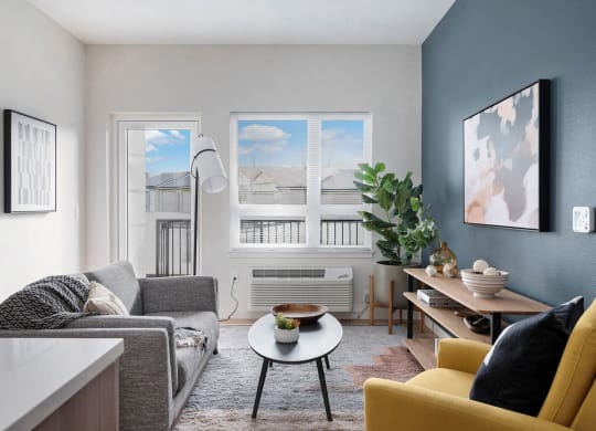 a living room with blue walls and a large window