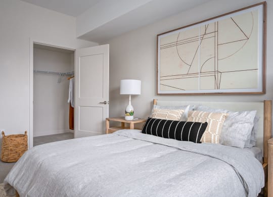 a bedroom with a bed and a nightstand with a lamp