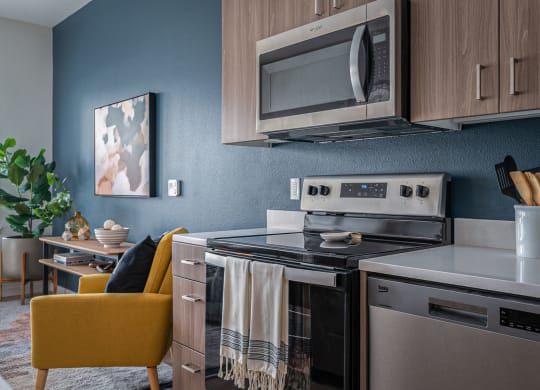 a kitchen with a stove top oven next to a microwave oven