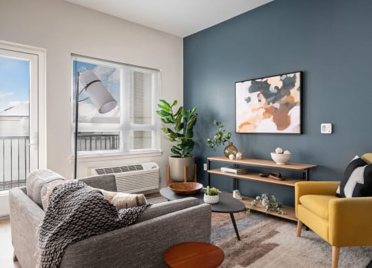 a living room with two couches and a yellow chair