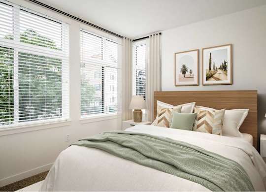 a bedroom with a bed and three windows