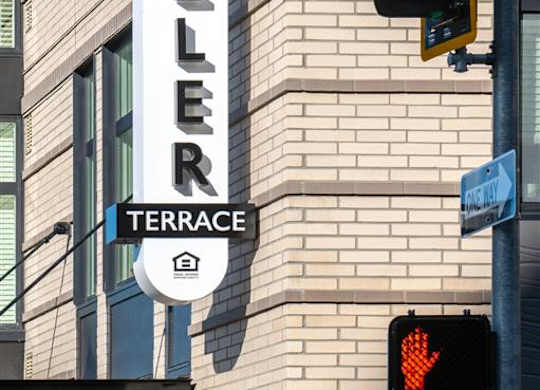 a traffic light and a sign on the side of a building