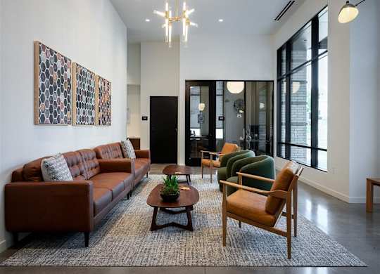 a living room with a couch and chairs and a rug