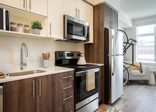 a kitchen with a sink and a refrigerator and a microwave