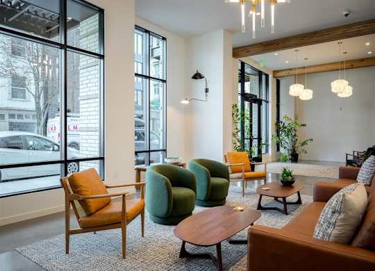 a living room with couches and chairs and a large window