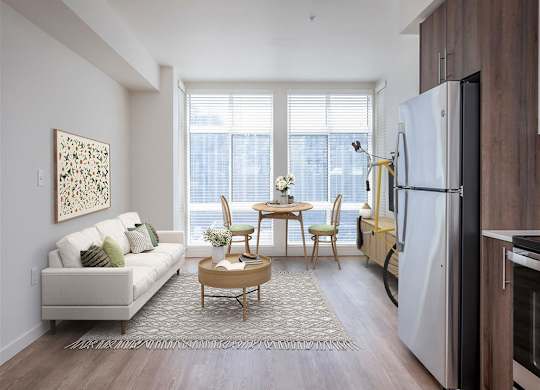 a living room with a couch and a table and a refrigerator