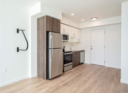 a kitchen with stainless steel appliances and a wood floor