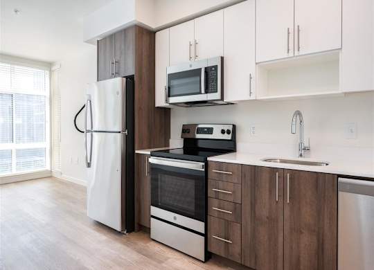 a kitchen with white cabinets and a stove and refrigerator