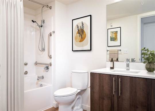 a bathroom with a toilet sink and shower and a mirror