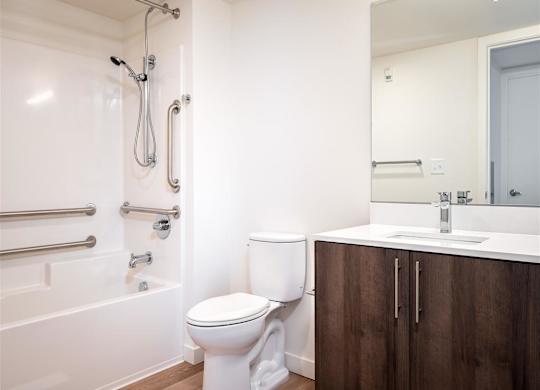 a bathroom with a toilet and a tub and a sink