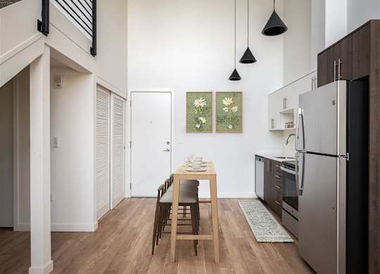 a kitchen with a wooden table and a refrigerator