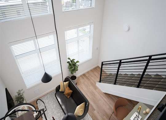 an overhead view of a living room with a bed and a futon