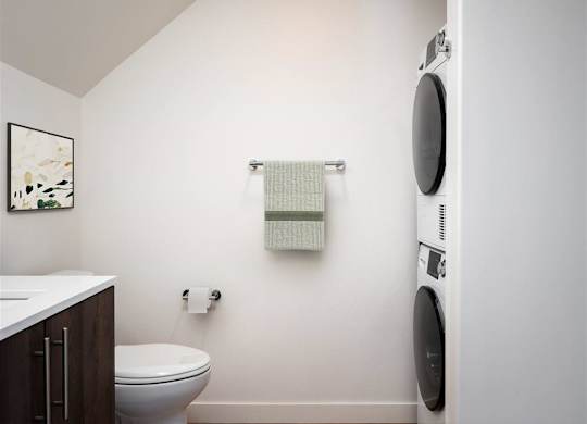 a small bathroom with a toilet and a washing machine