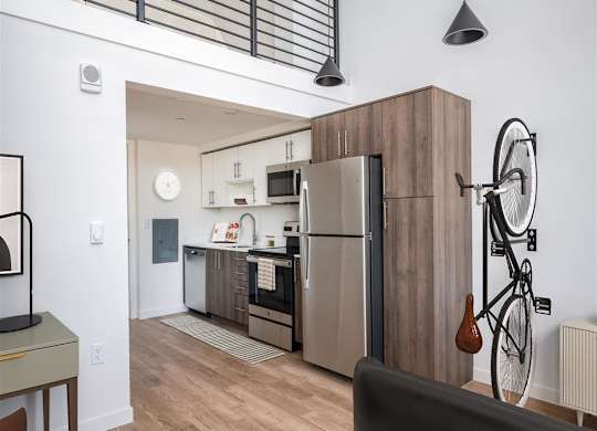 a kitchen with stainless steel appliances and a bike on the wall