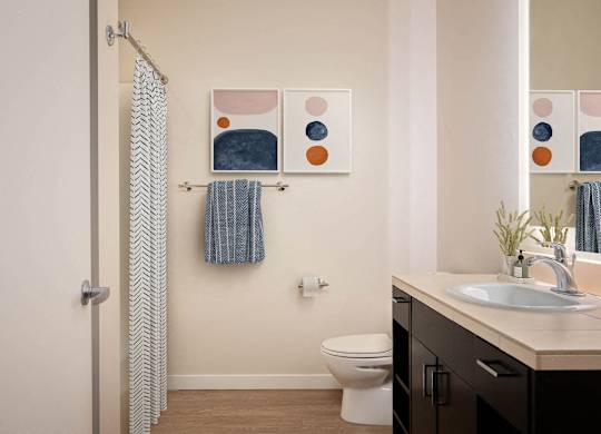 a bathroom with a shower curtain and a sink and a toilet