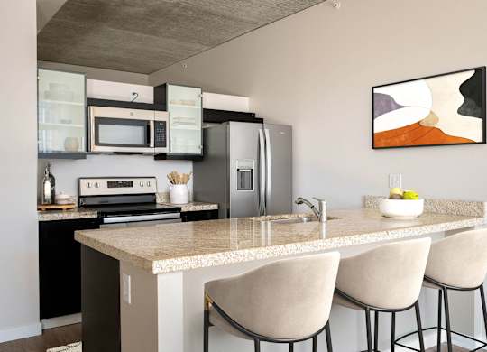 a kitchen with an island and a counter with chairs
