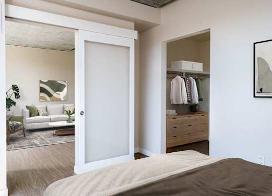 a bedroom with a bed and a closet with a mirror