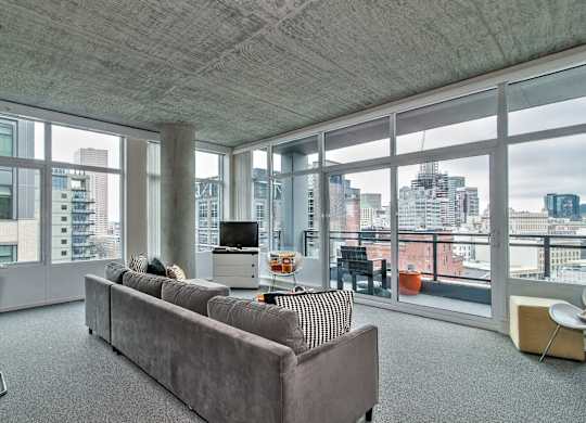 a living room with a couch and a view of the city