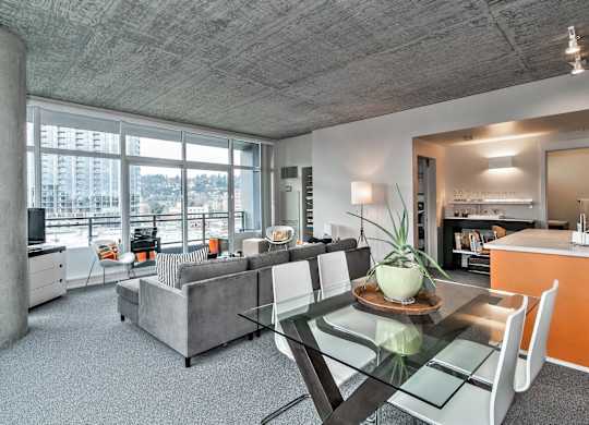 a living room with a glass table and a couch