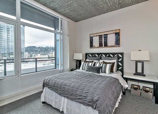 a bedroom with a bed and a large window