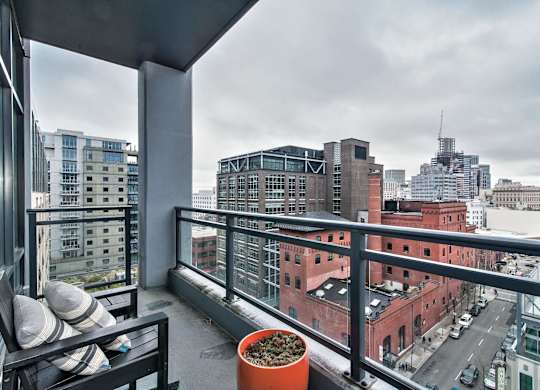 a view of the city from the balcony of a apartment